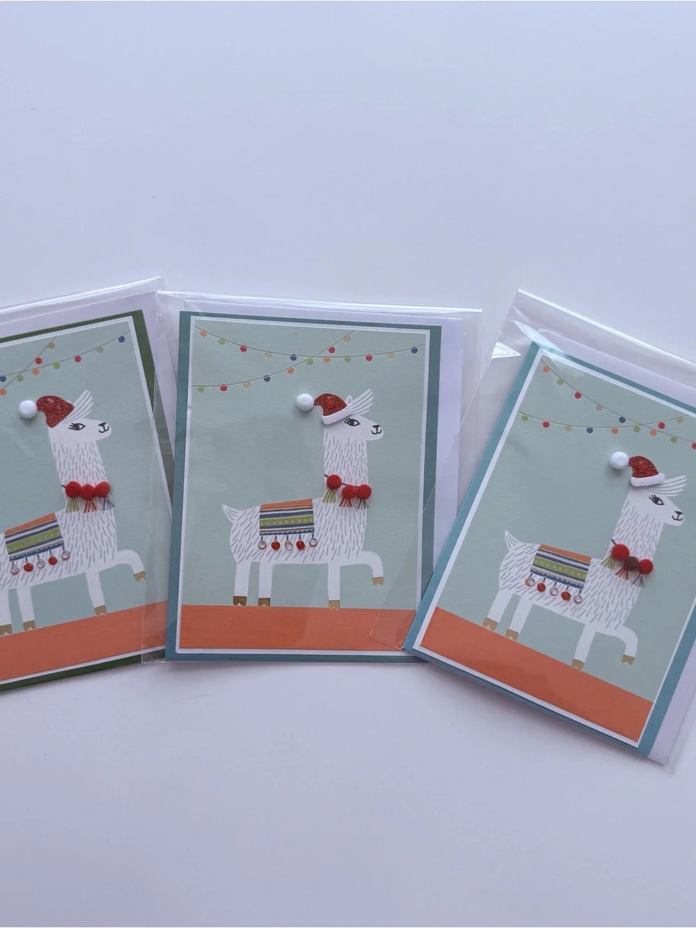 Llama Holiday Card - featuring an adorned “ticas” necklace & “aretes” blanket.